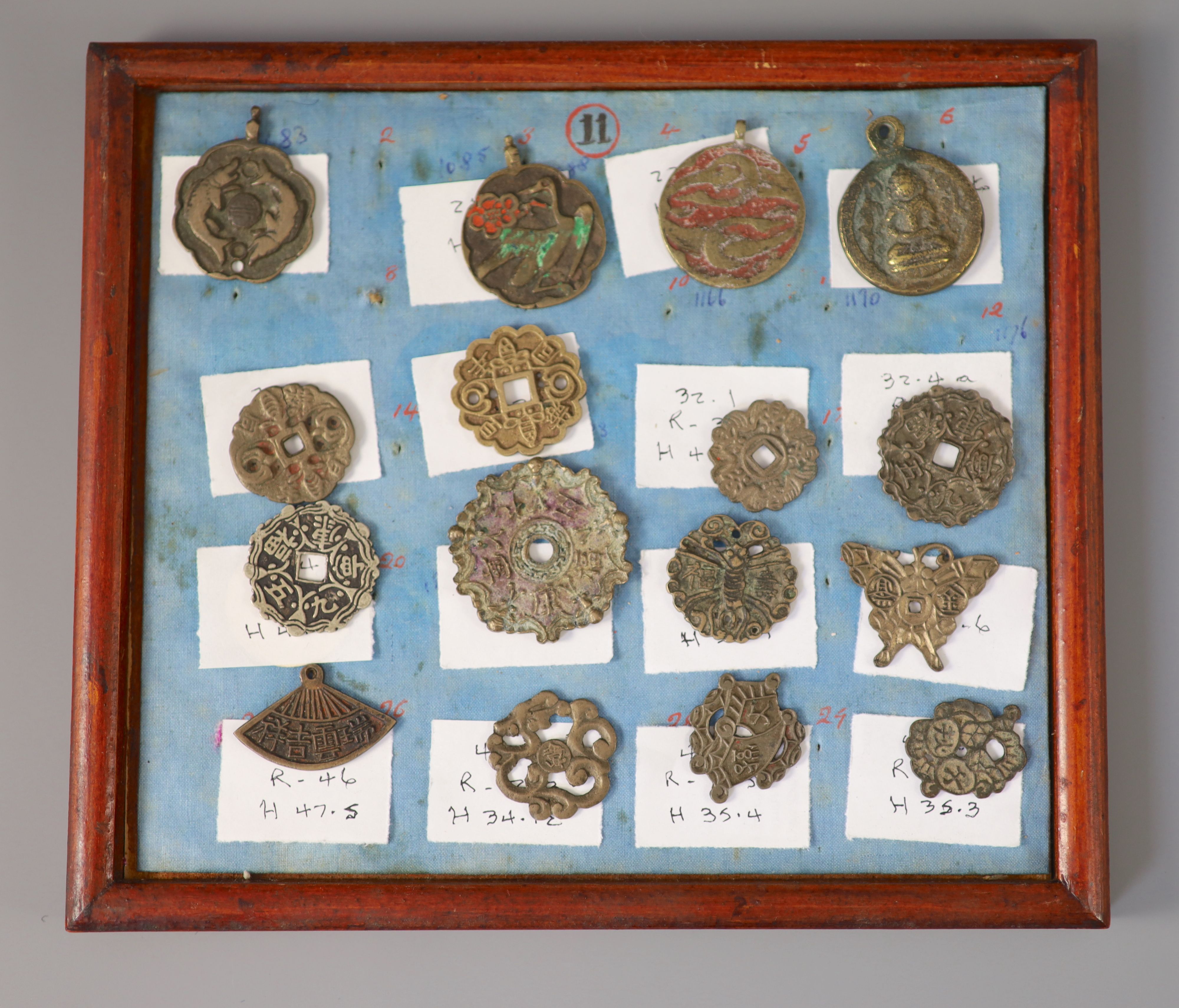 A group of 99 Korean bronze and metal amulets or charms, 19th/20th century